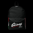 A black backpack with a front pocket featuring the text 'Skinny Joey's' in white script and a red underline, with vertical red, white, and green side stripes. The brand 'The Art of Being' is printed in white near the top handle.