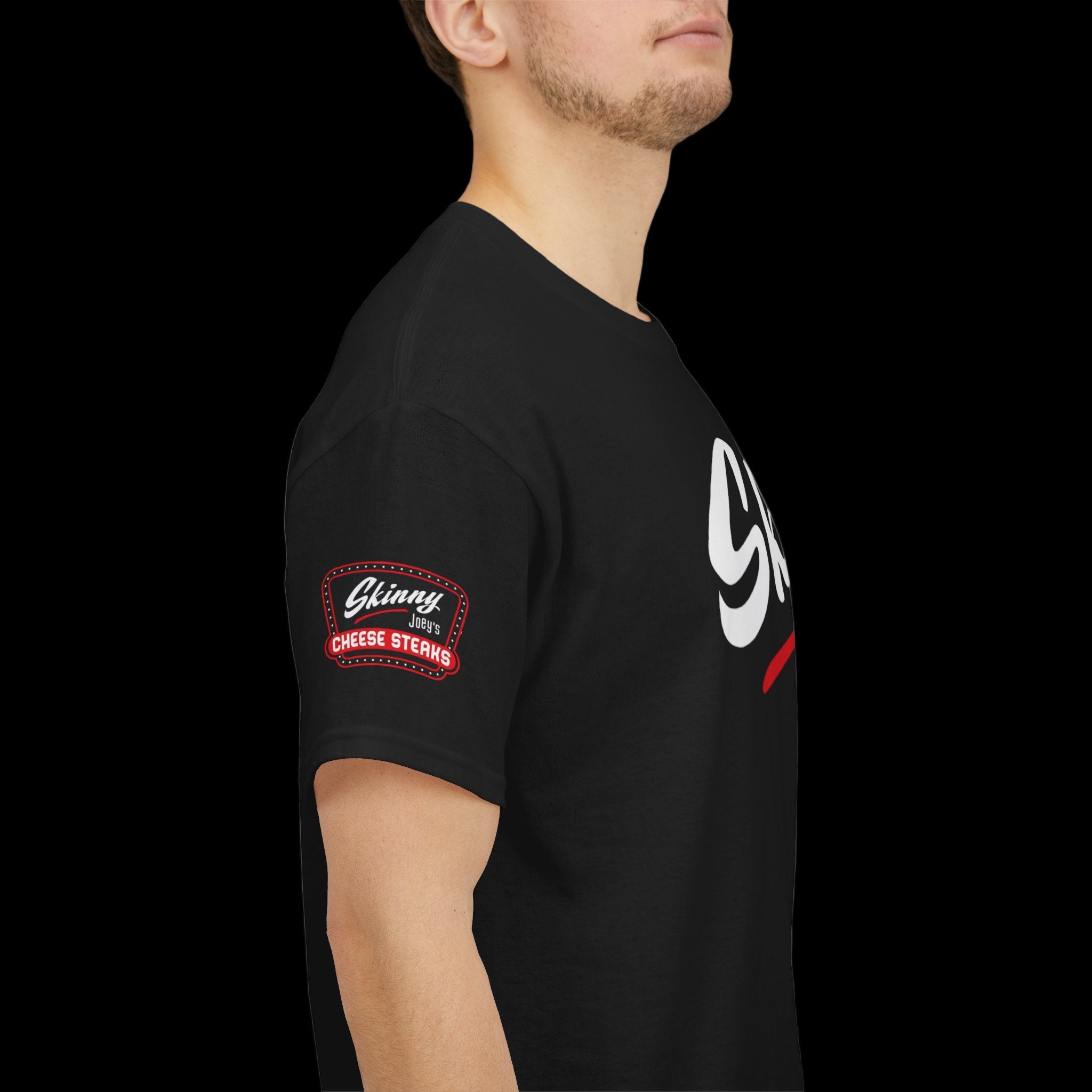 Person wearing a black t-shirt with a logo on the sleeve against a white background