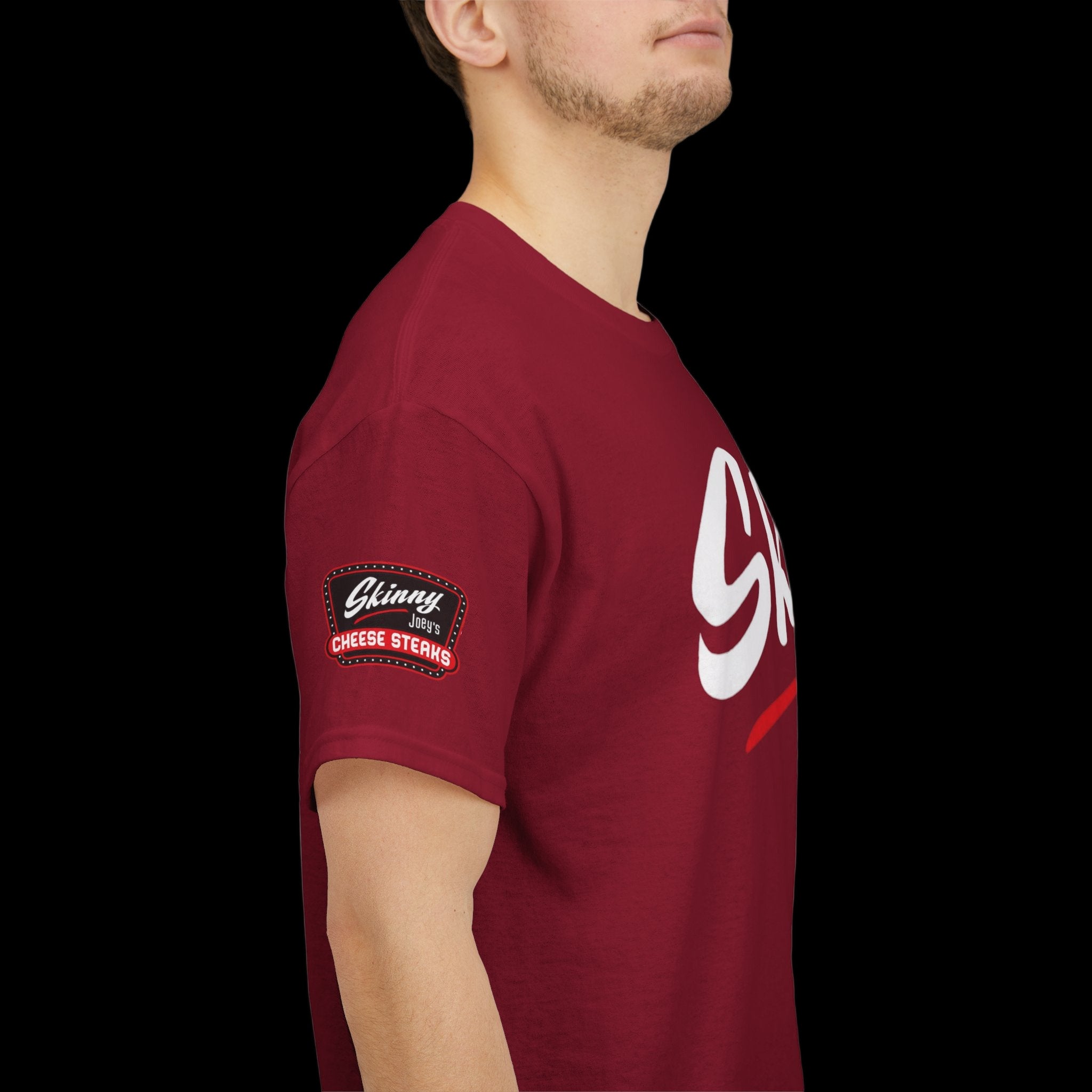 Red t-shirt with a logo on the sleeve worn by a person
