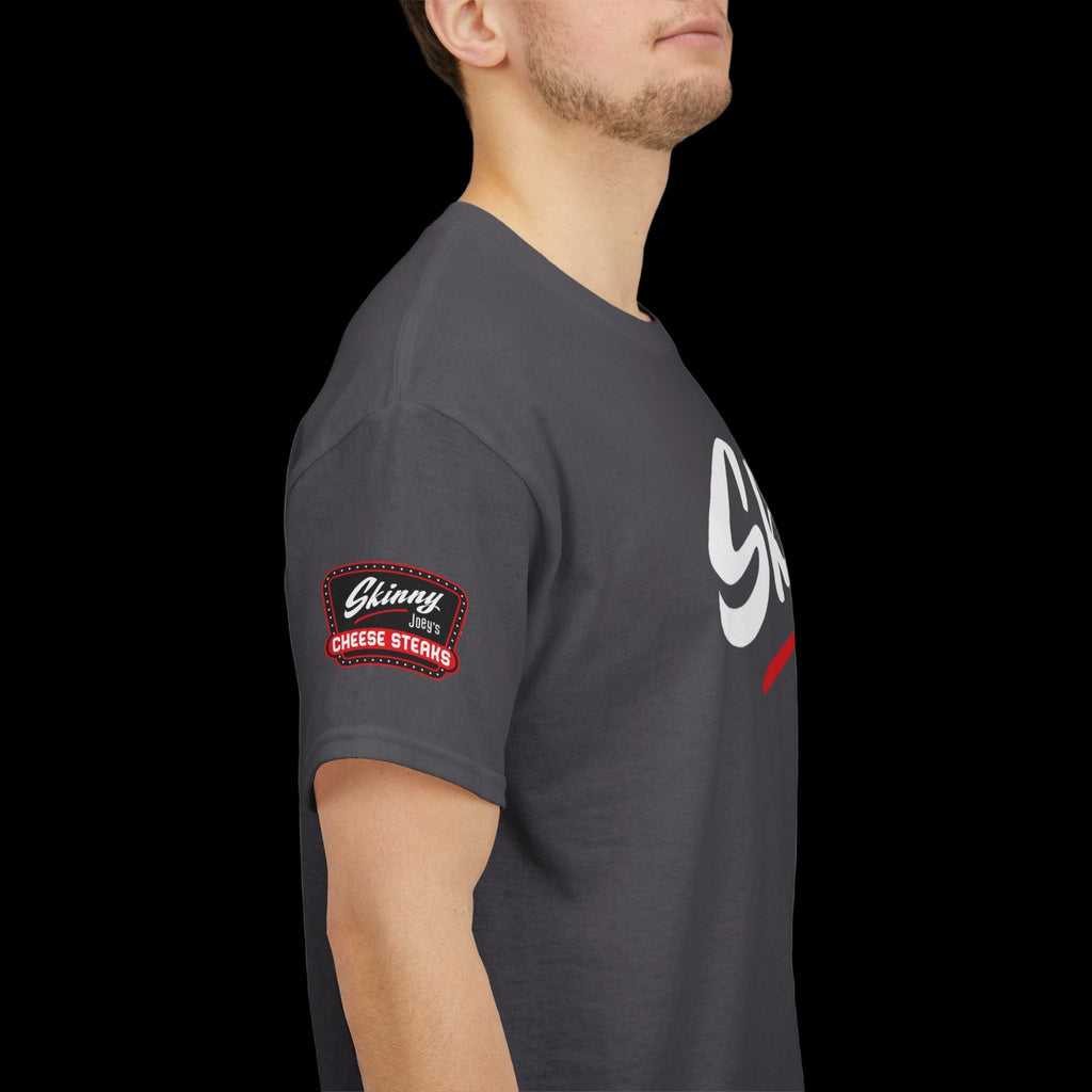 Person wearing a dark gray t-shirt with a logo on the sleeve against a white background