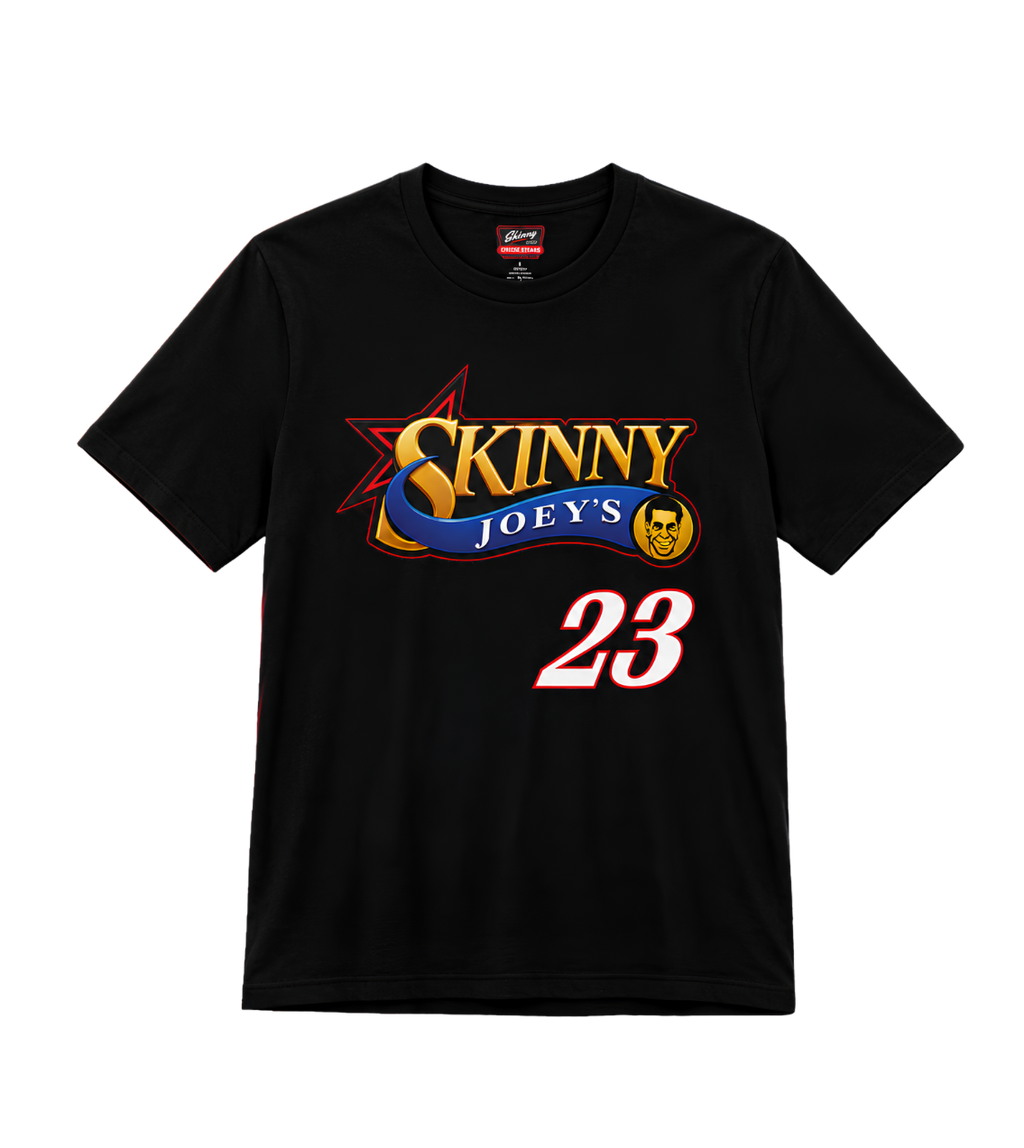 A black short-sleeve crewneck t-shirt featuring a graphic print of 'Skinny Joey's' in gold and blue lettering with a red star, and the number '23' in white with a red outline.