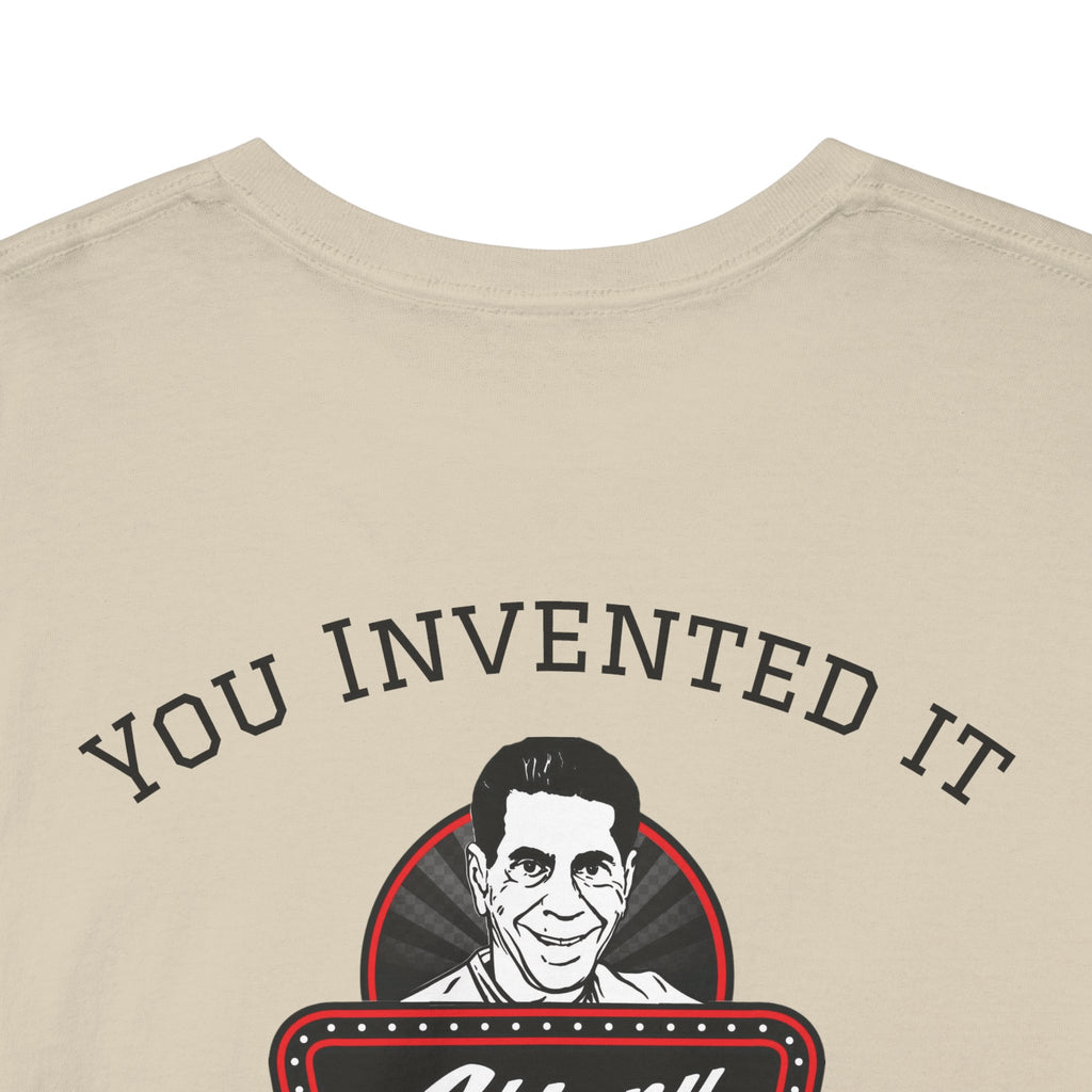 Beige t-shirt with a graphic of a person's face and text 'YOU INVENTED IT' on a white background