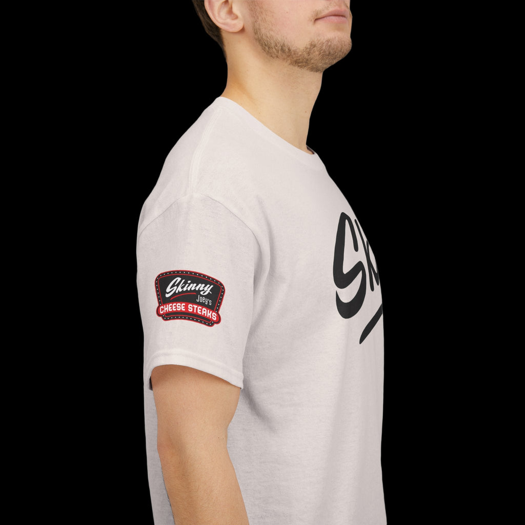 Person wearing a light gray t-shirt with a logo on the sleeve against a white background