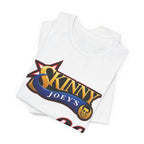 A folded white t-shirt featuring a graphic print of the 'Skinny Joey's' logo in gold, blue, and red, displayed on a clean white background.