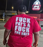 Customer wearing the Fuck Pat's & Fuck The Rats tee outside Skinny Joey's Cheesesteaks at night, back view
