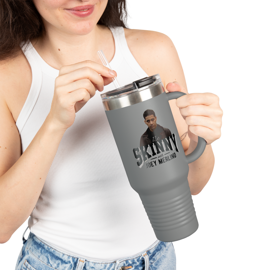 Person holding a gray travel mug with a graphic design on a white background