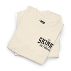 Folded beige sweatshirt with 'The Skinn with Joey Merlino' text on a white background