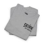 Folded gray t-shirt with 'The Skinn with Joey Merlino' text on a white background