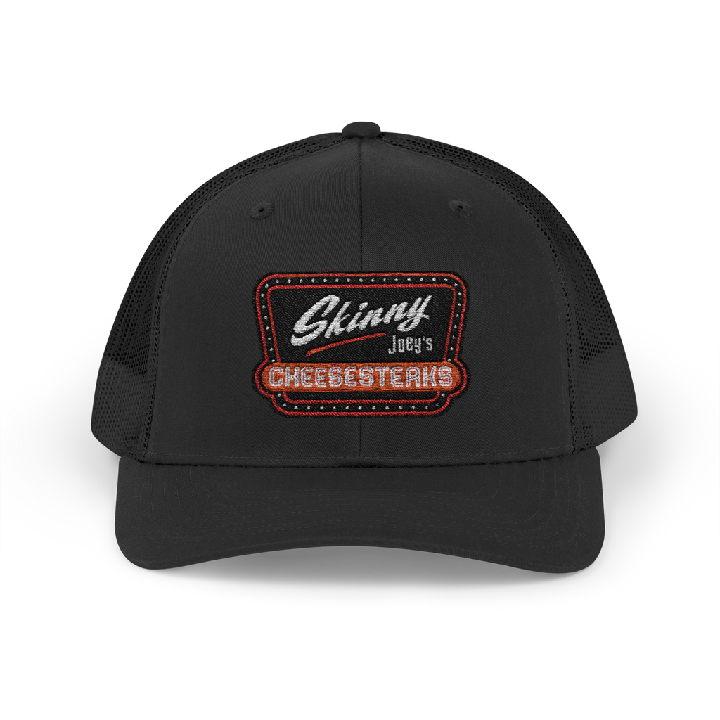 Black cap with 'Skinny Joey's Cheesesteaks' logo on a white background