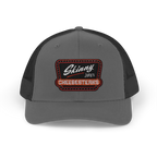 Gray trucker cap with a black mesh back and embroidered patch on a white background