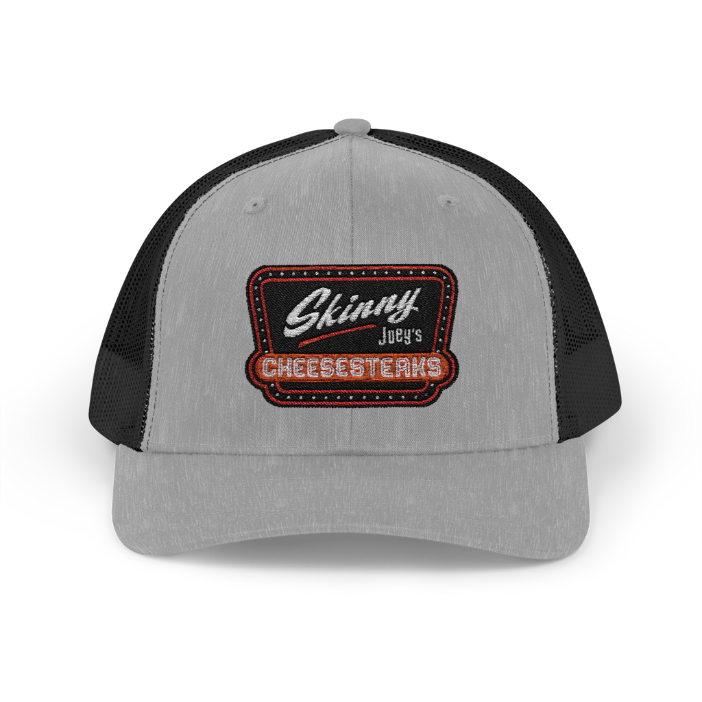 Gray and black trucker cap with 'Skinny Joey's Cheesesteaks' patch on a white background