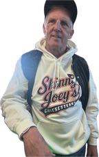 Man wearing a white hoodie with 'Skinny Joey's Cheesesteaks' text and graphics.