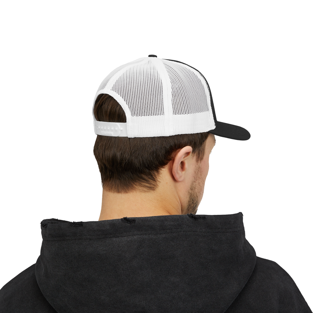Person wearing a black hoodie and white and black cap on a white background