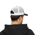Person wearing a black hoodie and white and black cap on a white background