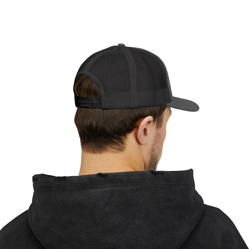 Person wearing a black cap and black hoodie on a white background