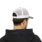 Person wearing a black hoodie and white and gray cap on a white background