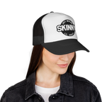Person wearing a black and white cap with 'Skinny' branding on a white background