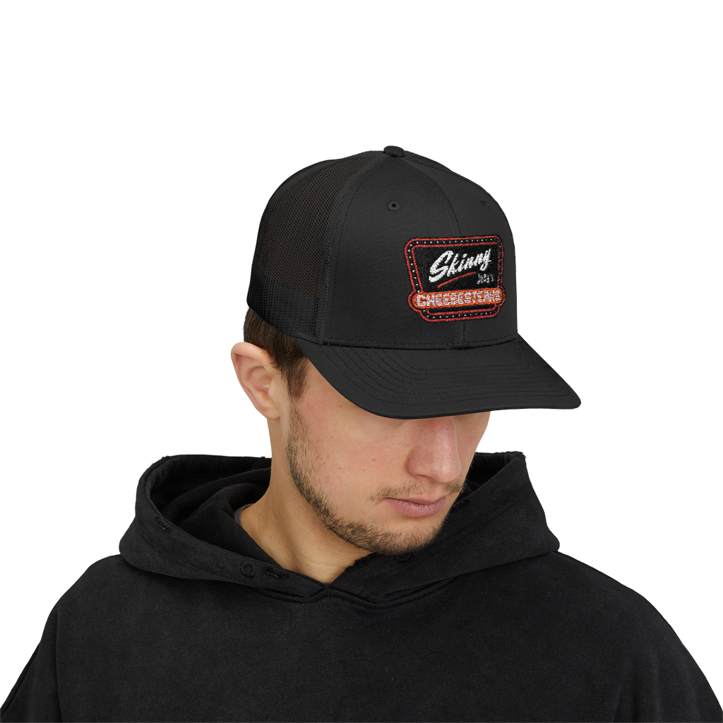 Person wearing a black cap with a logo on a white background