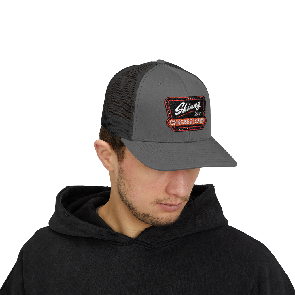 Person wearing a gray cap with a logo on a white background