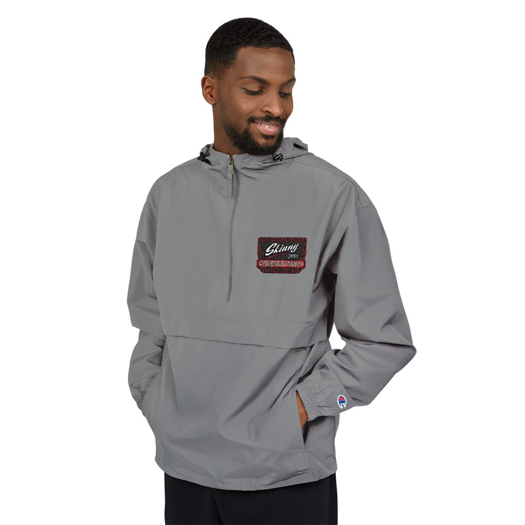 Man wearing a gray pullover with a brand logo on a white background