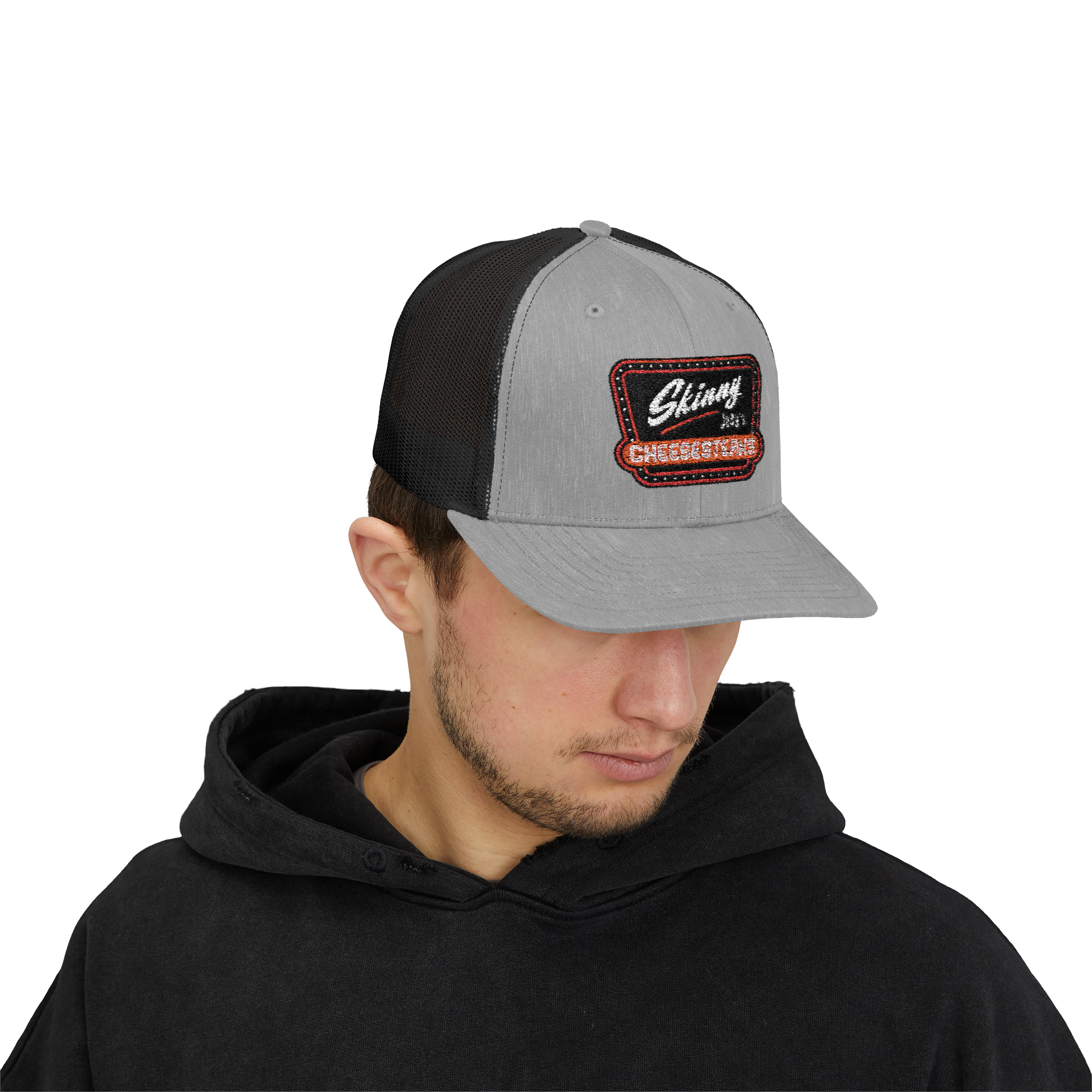 Person wearing a gray and black cap with a logo on a white background