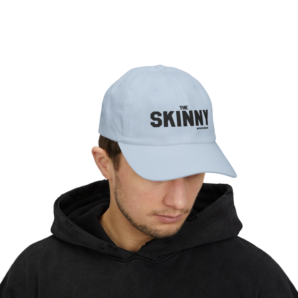 Person wearing a light blue cap with 'The Skinny' logo on a white background