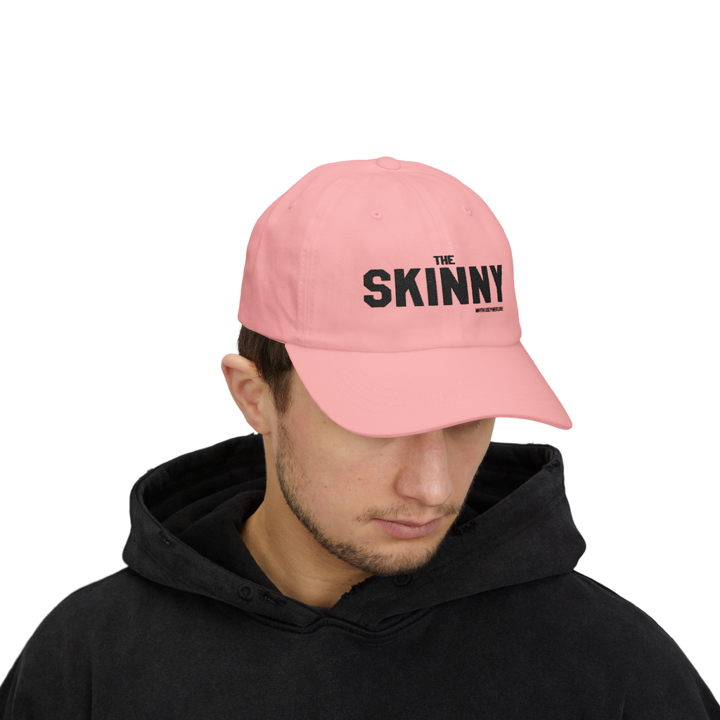 Person wearing a light blue cap with 'The Skinny' logo on a white background