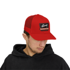 Person wearing a red cap with a logo on a white background