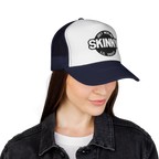 Person wearing a black and white cap with 'Skinny' branding on a white background