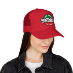 Red cap with 'Skinny' logo worn by a person on a white background