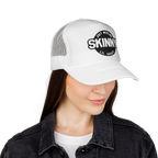 Person wearing a white cap with 'Skinny' logo on a white background
