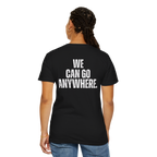 Person wearing a black t-shirt with 'WE CAN GO ANYWHERE.' text on the back, standing against a white background.