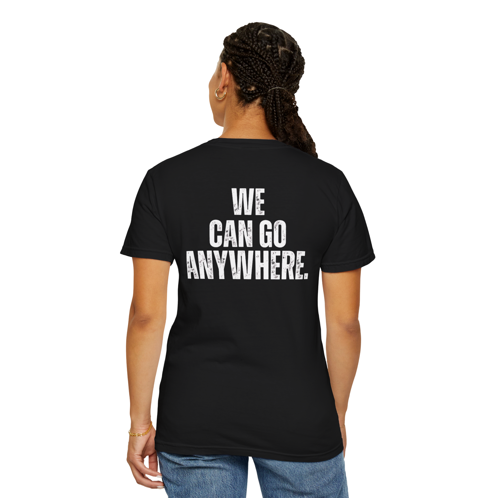 Person wearing a black t-shirt with 'WE CAN GO ANYWHERE.' text on the back, standing against a white background.