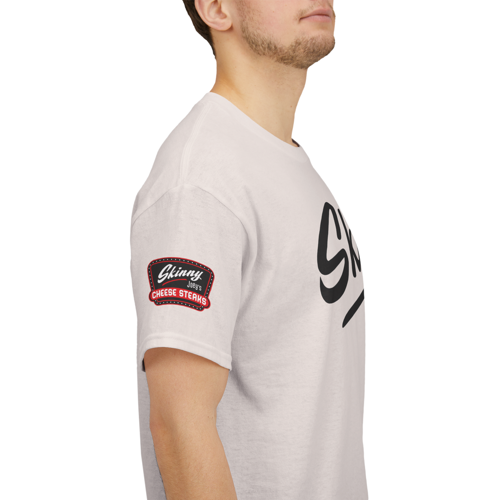 Person wearing a light gray t-shirt with a logo on the sleeve against a white background