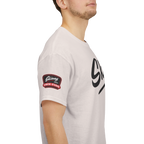 Person wearing a light gray t-shirt with a logo on the sleeve against a white background