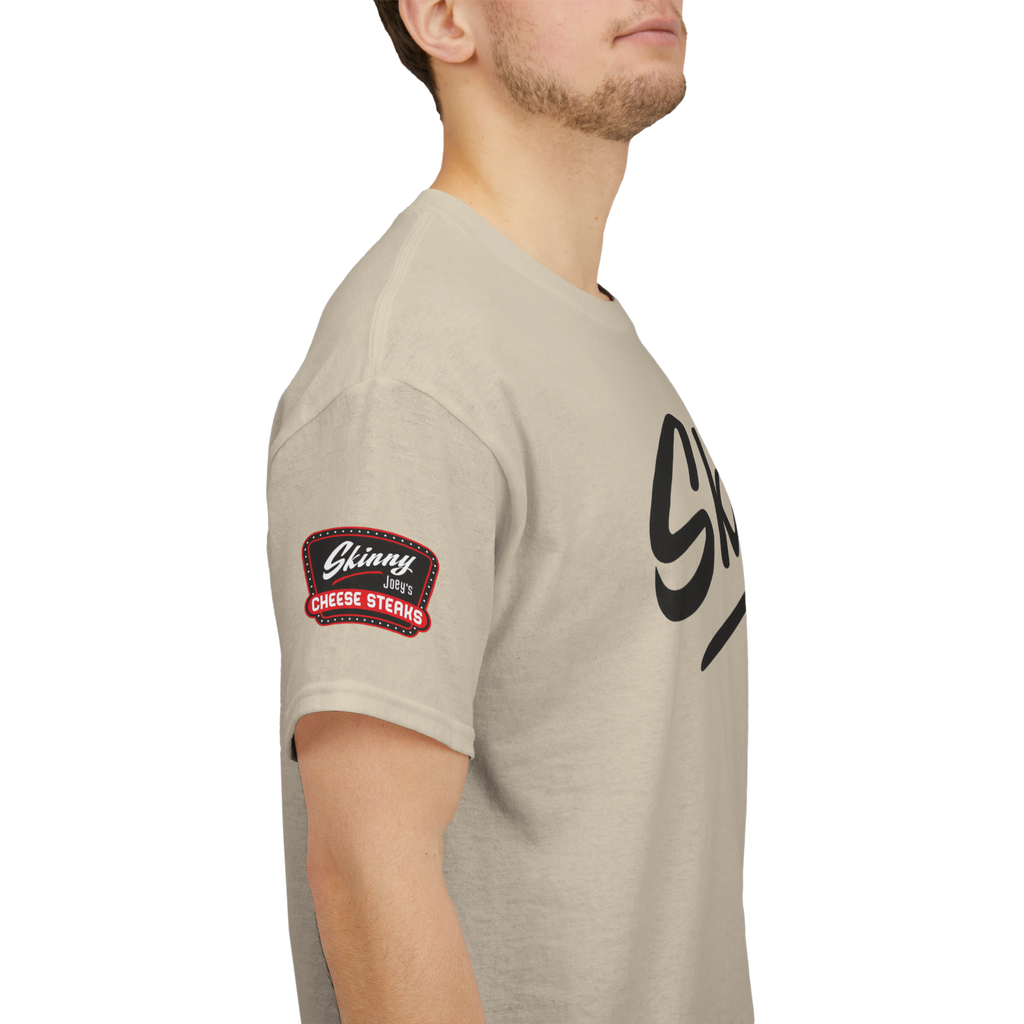 Beige t-shirt with a logo on the sleeve and brand name on the chest against a white background