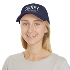 Person wearing a navy blue cap with 'The Skinny' text on a white background