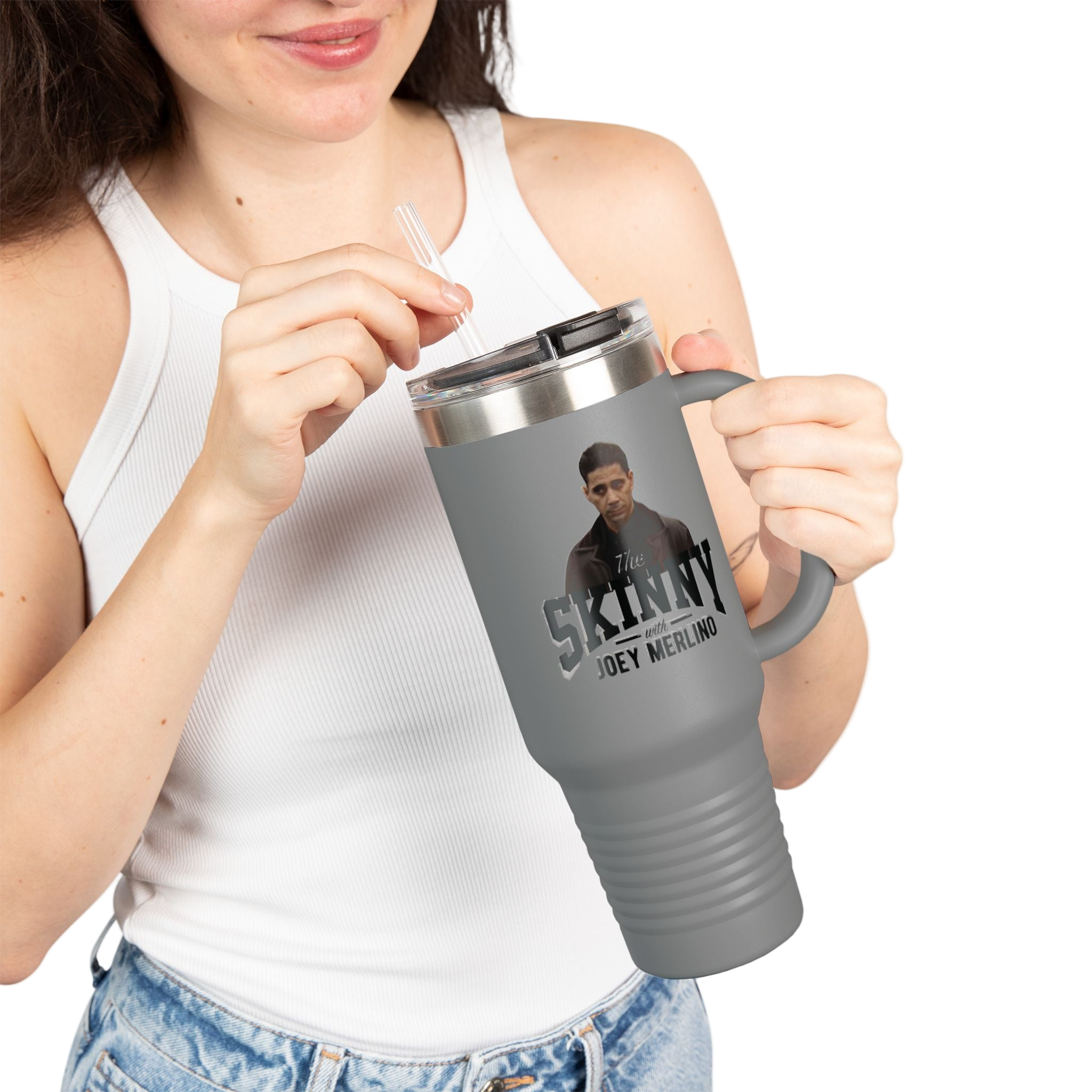 Person holding a gray travel mug with a graphic design on a white background