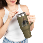 Person holding a green travel mug with a graphic design on a white background