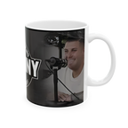 Mug with a person smiling and holding a microphone, featuring the text 'No Dizzy'.