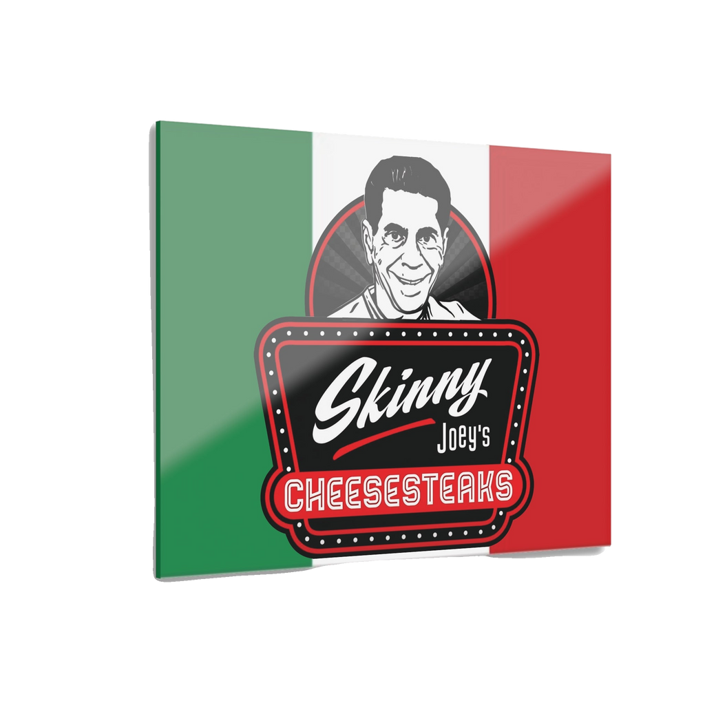 Metallic sign with 'Skinny Joey's Cheesesteaks' logo on a green, white, and red background